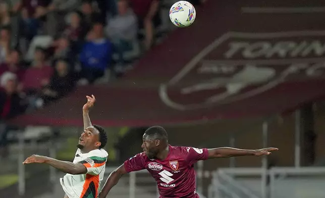 Torino's Ali Dembele, right, and Venezia's Ridgeciano Haps battle for a header during the Serie A soccer match between FC Torino and Venezia at the Olympic Stadium in Turin, Italy, Friday, May 2, 2025. (Spada/LaPresse via AP)