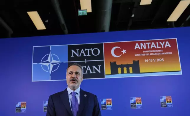 Turkey's Foreign Minister Hakan Fidan talks to journalists as he arrives for a NATO's informal meeting of foreign ministers in Antalya, southern Turkey, Thursday, May 15, 2025. (AP Photo/Khalil Hamra)