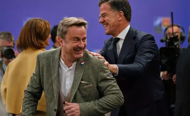 NATO Secretary-General Mark Rutte, right, talks to Luxembourg's Foreign Minister Xavier Bettel as they arrive for a group photo during a NATO's informal meeting of foreign ministers in Antalya, southern Turkey, Thursday, May 15, 2025. (AP Photo/Khalil Hamra)