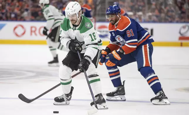 Dallas Stars' Sam Steel (18) is chased by Edmonton Oilers' Evander Kane (91) during the second period of Game 3 of the NHL hockey Stanley Cup Western Conference finals in Edmonton, Alberta, Sunday, May 25, 2025. (Jason Franson/The Canadian Press via AP)