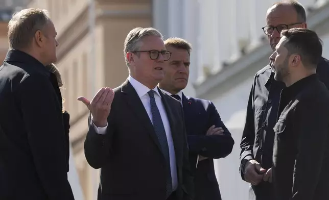 From left, Polish Prime Minister Donald Tusk, British Prime Minister Keir Starmer, French President Emmanuel Macron, German Chancellor Friedrich Merz, and Ukrainian President Volodymyr Zelenskyy, stand at the memorial of fallen Ukrainian soldiers at independence square in Kyiv, Ukraine, on Saturday, May 10, 2025. (AP Photo/Evgeniy Maloletka)