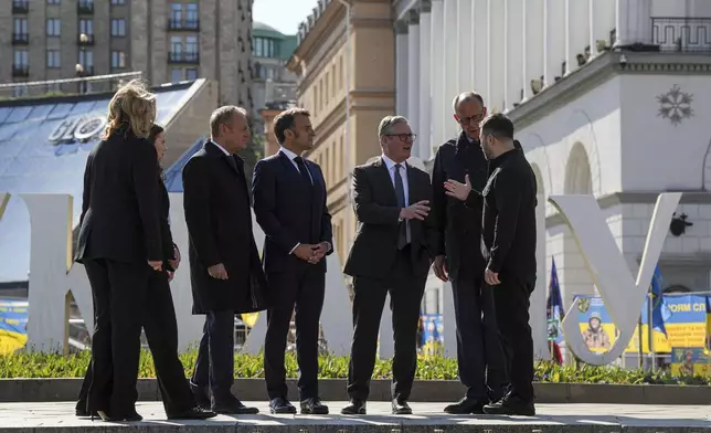 From left, Polish Prime Minister Donald Tusk, Ukraine's First Lady Olena Zelenska Olena Zelenska, British Prime Minister Keir Starmer, French President Emmanuel Macron, German Chancellor Friedrich Merz, and Ukrainian President Volodymyr Zelenskyy, stand at the memorial of fallen Ukrainian soldiers at independence square in Kyiv, Ukraine, on Saturday, May 10, 2025. (AP Photo/Evgeniy Maloletka)