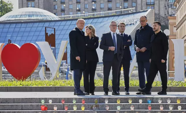From left, Poland's Prime Minister Donald Tusk, Olena Zelenska, Britain's Prime Minister Keir Starmer, France's President Emmanuel Macron, Germany's Chancellor Friedrich Merz and Ukraine's President Volodymyr Zelensky pose for a picture at the Independence Square in Kyiv, Ukraine, Saturday, May 10, 2025. (Ludovic Marin, Pool Photo via AP)