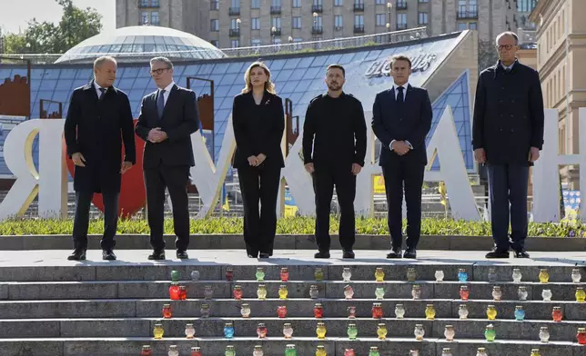 From left, Poland's Prime Minister Donald Tusk, , Britain's Prime Minister Keir Starmer, Olena Zelenska, Ukraine's President Volodymyr Zelensky, France's President Emmanuel Macron, and Germany's Chancellor Friedrich Merz pose for a picture at the Independence Square in Kyiv, Ukraine, Saturday, May 10, 2025. (Ludovic Marin, Pool Photo via AP)