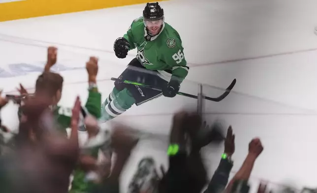 Fans and Dallas Stars' Mikko Rantanen, celebrate after Rantanen scored an emtpy-net goal against the Colorado Avalanche in the third period in Game 7 of a first-round NHL hockey playoff series Saturday, May 3, 2025, in Dallas. (AP Photo/Julio Cortez)