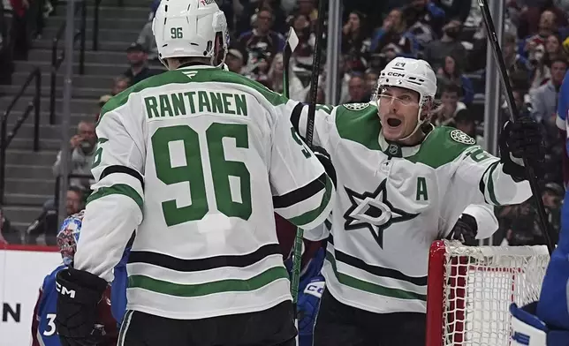 Dallas Stars right wing Mikko Rantanen (96) congratulates center Roope Hintz, after, after his goal in the second period of Game 6 of an NHL hockey first-round playoff series against the Colorado Avalanche, Thursday, May 1, 2025, in Denver. (AP Photo/David Zalubowski)