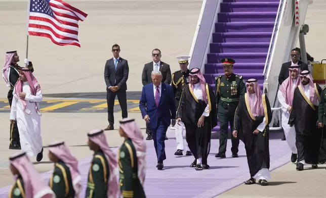 President Donald Trump walks with Saudi Crown Prince Mohammed bin Salman during an arrival ceremony at the Royal Terminal of King Khalid International Airport in Riyadh, Saudi Arabia, Tuesday, May 13, 2025.(AP Photo/Alex Brandon)