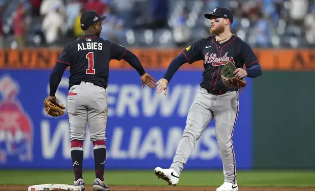 Atlanta Braves' Alex Verdugo, right, and Ozzie Albies celebrate after the Braves won the second baseball game of a doubleheader against the Philadelphia Phillies Thursday, May 29, 2025, in Philadelphia. (AP Photo/Matt Slocum)