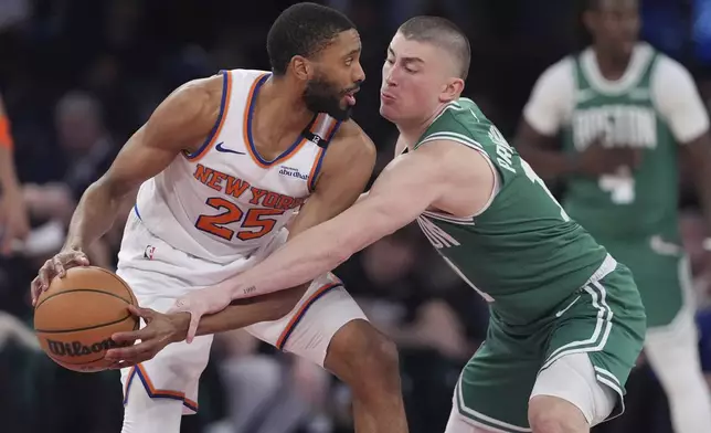 Boston Celtics' Payton Pritchard, right, defends New York Knicks' Mikal Bridges during the second half of Game 6 in the Eastern Conference semifinals of the NBA basketball playoffs Friday, May 16, 2025, in New York. (AP Photo/Frank Franklin II)