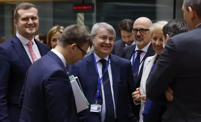 Hungarian Minister for European Union Affairs Janos Boka, front left, speaks with Italy's Permanent Representative to the EU Vincenzo Celeste, center, during a meeting of the general affairs ministers at the European Council building in Brussels, Tuesday, May 27, 2025. (AP Photo/Omar Havana)