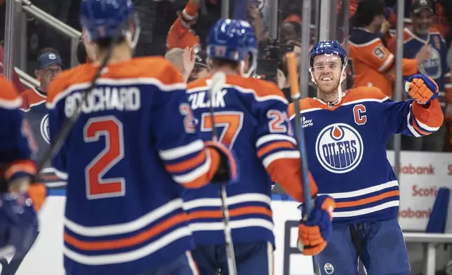 Edmonton Oilers' Connor McDavid (97) celebrates the win with teammates over the Los Angeles Kings during NHL playoff action in Edmonton on Thursday, May 1, 2025. (Jason Franson/The Canadian Press via AP)