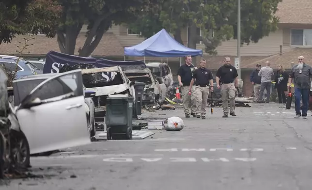 Investigators work at the site of a plane crash Friday, May 23, 2025, in San Diego. (AP Photo/Gregory Bull)