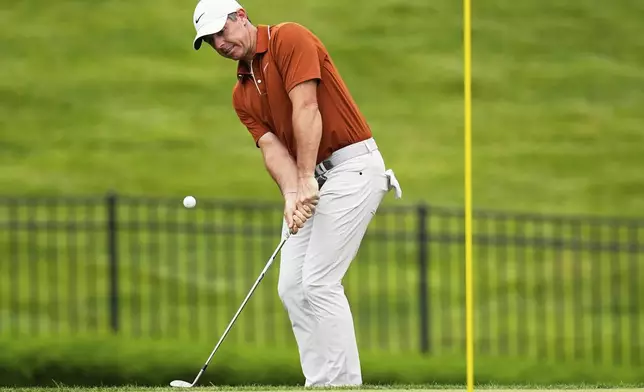 Rory McIlroy, of Northern Ireland, chips to the green on the seventh hole during the second round of the PGA Championship golf tournament at the Quail Hollow Club, Friday, May 16, 2025, in Charlotte, N.C. (AP Photo/David J. Phillip)