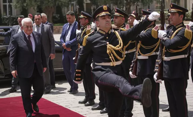 Palestinian President Mahmoud Abbas, left, reviews an honor guard upon his arrival to meet with Lebanese Prime Minister Nawaf Salam at the Government Palace in Beirut, Lebanon, Thursday, May 22, 2025. (AP Photo/Hassan Ammar)