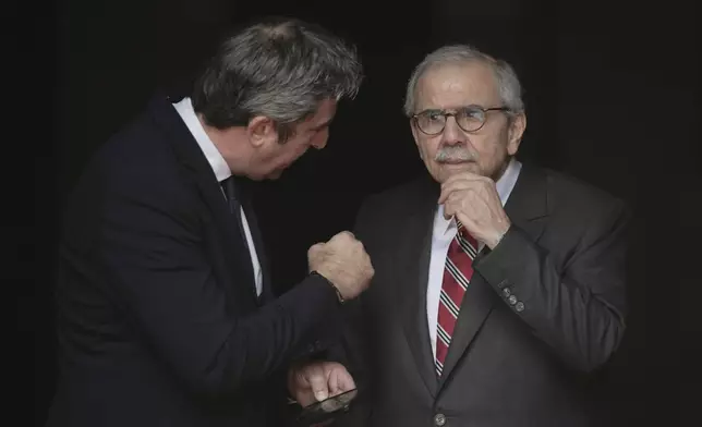 Lebanese Prime Minister Nawaf Salam, right, gestures as he speaks with an official while waiting to welcome Palestinian President Mahmoud Abbas at the Government Palace in Beirut, Lebanon, Thursday, May 22, 2025. (AP Photo/Hassan Ammar)