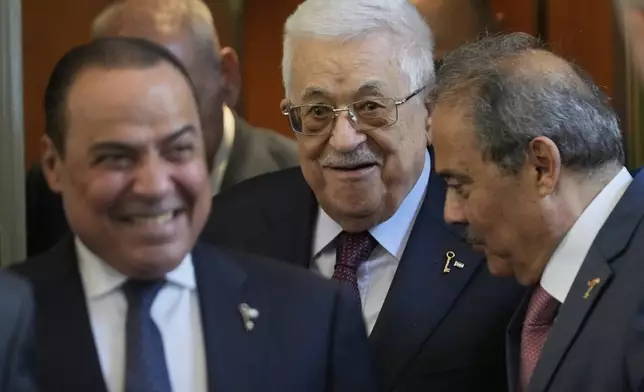 Palestinian President Mahmoud Abbas, centre, smiles as he leaves after his meeting with Lebanese Parliament Speaker Nabih Berri, in Beirut, Lebanon, Thursday, May 22, 2025. (AP Photo/Hussein Malla)
