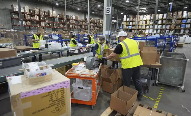 FILE - Employees of Learning Resources, an educational toy company, work at a warehouse in Vernon Hills, Ill., Friday, April 11, 2025. (AP Photo/Nam Y. Huh, File)