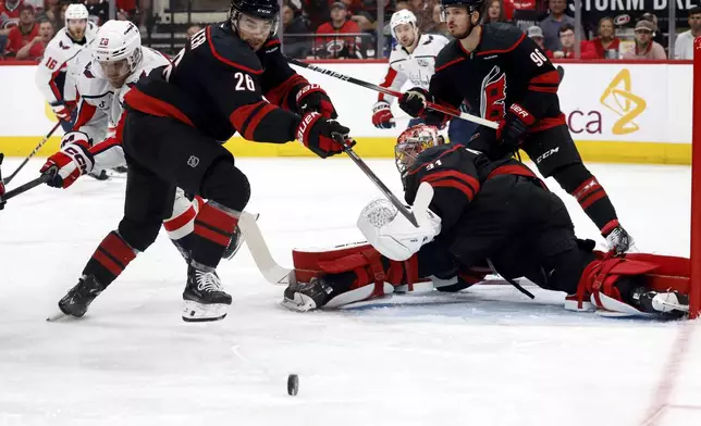 Carolina Hurricanes' Sean Walker (26) clears the puck away from goaltender Frederik Andersen (31) and Washington Capitals' Lars Eller (20) during the first period of Game 3 of an NHL hockey Semi-final round playoff series in Raleigh, N.C., Saturday, May 10, 2025. (AP Photo/Karl DeBlaker)