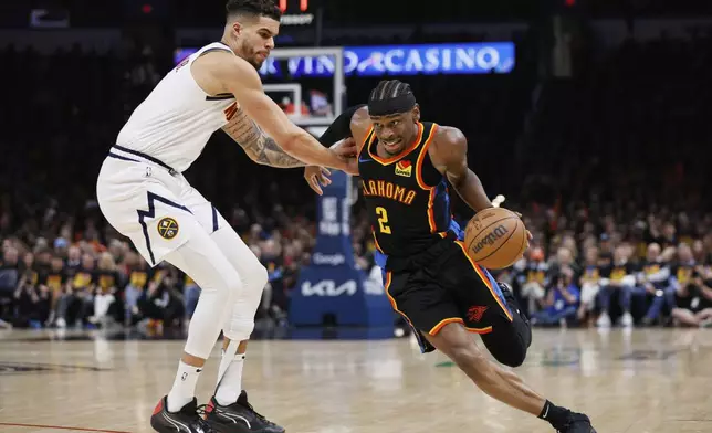 Oklahoma City Thunder guard Shai Gilgeous-Alexander (2) works to get past Denver Nuggets forward Michael Porter Jr., left, in the second half of Game 1 of an NBA basketball second-round playoff series Monday, May 5, 2025, in Oklahoma City. (AP Photo/Nate Billings)