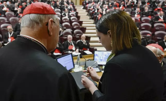 A Vatican employee annulls the papal seal on the pope's fisherman's ring, at the Vatican, Tuesday, May 6, 2025. (Vatican Media via AP)