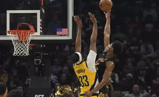 Cleveland Cavaliers forward De'Andre Hunter, right, shoots as Indiana Pacers center Myles Turner defends during the first half in Game 5 of an Eastern Conference semifinal NBA basketball playoff Tuesday, May 13, 2025, in Cleveland. (AP Photo/Sue Ogrocki)