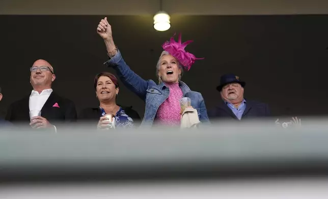 A fan cheers during a race at Churchill Downs before the 151st running of the Kentucky Derby horse race Saturday, May 3, 2025, in Louisville, Ky. (AP Photo/Brynn Anderson)