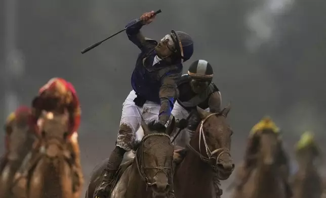 Jockey Junior Alvarado celebrates after riding Sovereignty to victory in the 151st running of the Kentucky Derby horse race at Churchill Downs Saturday, May 3, 2025, in Louisville, Ky. (AP Photo/Brynn Anderson)