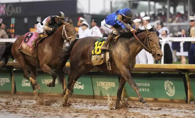 Sovereignty, right, ridden by Junior Alvarado, crosses the finish line to win the 151st running of the Kentucky Derby horse race followed by Journalism, ridden by Umberto Rispoli, at Churchill Downs Saturday, May 3, 2025, in Louisville, Ky. (AP Photo/Jeff Roberson)