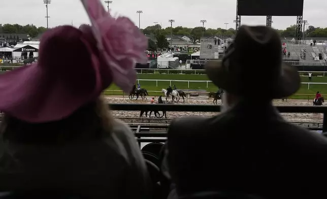 Race fans watch from the stands at Churchill Downs before the 151st running of the Kentucky Derby horse race Saturday, May 3, 2025, in Louisville, Ky. (AP Photo/Brynn Anderson)