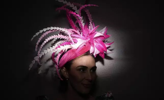 A race fan stands against a wall at Churchill Downs before the 151st running of the Kentucky Derby horse race Saturday, May 3, 2025, in Louisville, Ky. (AP Photo/Brynn Anderson)