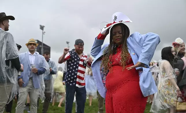 Race enjoy the grounds at Churchill Downs before the 151st running of the Kentucky Derby horse race Saturday, May 3, 2025, in Louisville, Ky. (AP Photo/Jon Cherry)