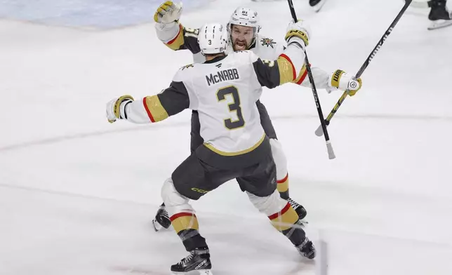 Vegas Golden Knights right wing Mark Stone (61) celebrates with defenseman Brayden McNabb (3) after scoring during the third period of Game 6 of a first-round NHL hockey playoff series against the Minnesota Wild, Thursday, May 1, 2025, in St. Paul, Minn. (AP Photo/Bailey Hillesheim)