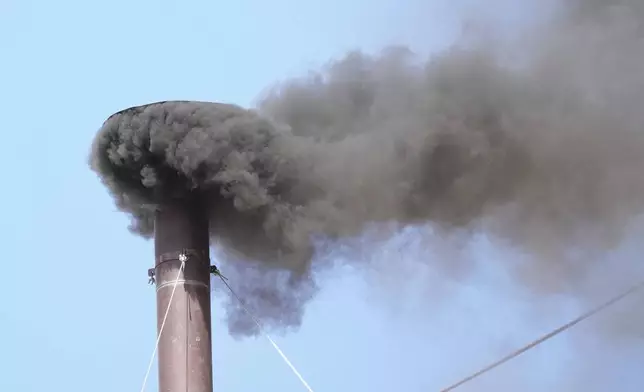 Black smoke billows from the chimney of the Sistine Chapel during the conclave to elect a new pope, at the Vatican, Thursday, May 8, 2025. (AP Photo/Andrew Medichini)