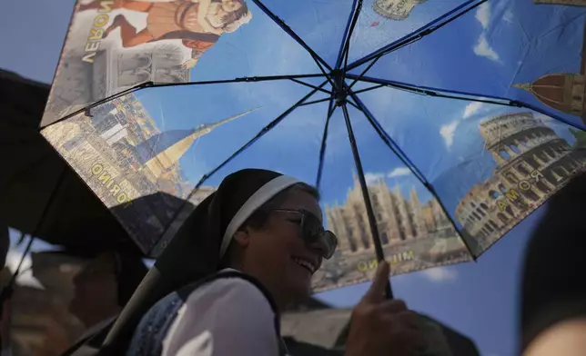 Nuns from Mexico gather at St. Peter's Basilica waiting for smoke to billow from the chimney of the Sistine Chapel where 133 cardinals are gathering on the second day of the conclave to elect a successor to late Pope Francis, at the Vatican, Thursday, May 8, 2025. (AP Photo/Francisco Seco)