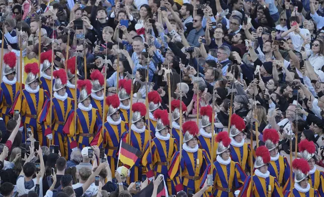 Swiss Guards march after a new Pope was elected when 133 cardinals gathered on the second day of the conclave to select a successor to the late Pope Francis, at the Vatican, Thursday, May 8, 2025. (AP Photo/Markus Schreiber)