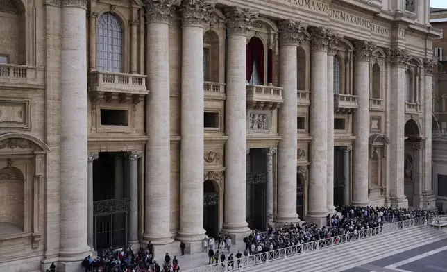 People gather under Pope's balcony in St. Peter's Square where 133 cardinals are gathering on the second day of the conclave to elect successor of late Pope Francis, at the Vatican, Thursday, May 8, 2025. (AP Photo/Gregorio Borgia)