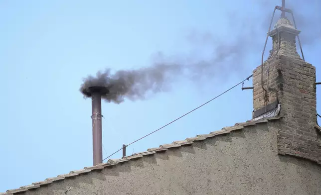 smoke billows from the chimney of the Sistine Chapel during the conclave to elect a new pope, at the Vatican, Thursday, May 8, 2025. (AP Photo/Andrew Medichini)