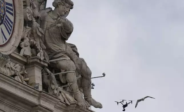 A drone used for TV broadcast is attacked by a seagull above St. Peter's Square where 133 cardinals are gathering on the second day of the conclave to elect successor of late Pope Francis, at the Vatican, Thursday, May 8, 2025. (AP Photo/Gregorio Borgia)