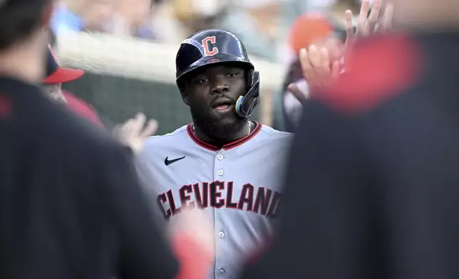 Cleveland Guardians' Jhonkensy Noel celebrates in the dugout after scoring a run against the Detroit Tigers in the third inning of a baseball game Saturday, May 24, 2025, in Detroit. (AP Photo/Lon Horwedel)