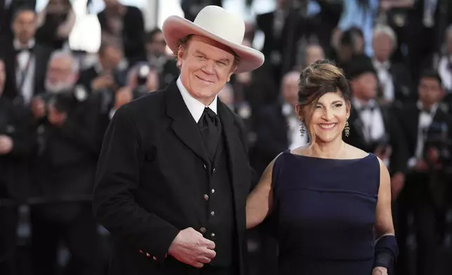 John C. Reilly, left, and Alison Dickey pose for photographers during the awards ceremony red carpet at the 78th international film festival, Cannes, southern France, Saturday, May 24, 2025. (AP Photo/Natacha Pisarenko)
