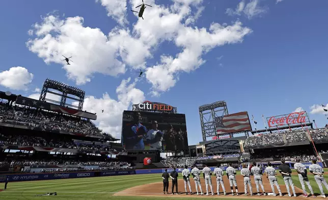 United States Army helicopters perform a flyover before a baseball game between the Chicago White Sox and the New York Mets, Monday, May 26, 2025, in New York. (AP Photo/Adam Hunger)