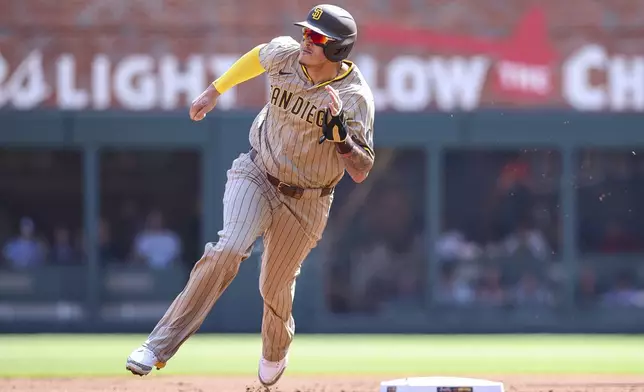 San Diego Padres' Manny Machado rounds second base in the first inning of a baseball game against the Atlanta Braves, Saturday, May 24, 2025, in Atlanta. (AP Photo/Colin Hubbard)