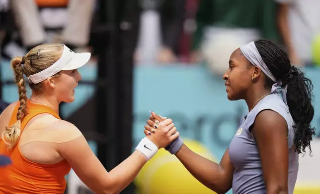 United States' Coco Gauff, right, shakes hands after her victory Mirra Andreeva of Russia at the Madrid Open quarter-final tennis match in Madrid, Spain, Wednesday, April 30, 2025. (AP Photo/Manu Fernandez)