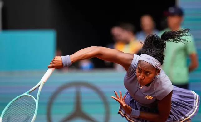 United States' Coco Gauff serves against Mirra Andreeva of Russia at the Madrid Open quarter-final tennis match in Madrid, Spain, Wednesday, April 30, 2025. (AP Photo/Manu Fernandez)