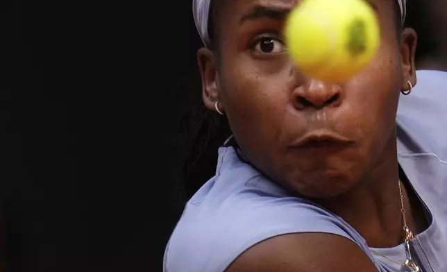 United States' Coco Gauff eyes the ball as she plays Mirra Andreeva of Russia at the Madrid Open quarter-final tennis match in Madrid, Spain, Wednesday, April 30, 2025. (AP Photo/Manu Fernandez)