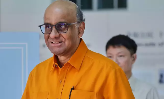 President of Singapore, Tharman Shanmugaratnam leaves the polling station after casting his vote during the general election in Singapore, Saturday, May 3, 2025. (AP Photo/Suhaimi Abdullah)