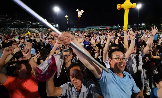 Workers' Party (WP) supporters react at an assembly centre during the general election, in Singapore, Saturday, May 3, 2025. (AP Photo/Suhaimi Abdullah)