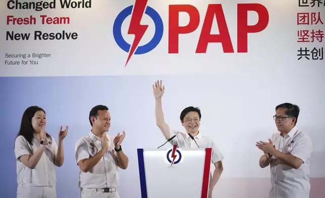 Prime Minister Lawrence Wong's, from People's Action Party (PAP), second from right, thanks his supporters and voters at an assembly area for People's Action Party supporters, on the day of the general election in Singapore, Saturday, May 3, 2025. (AP Photo/Vincent Thian)