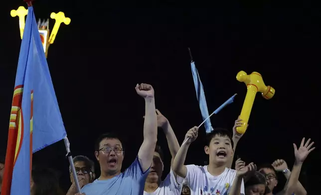Workers' Party (WP) supporters react at an assembly center during the general election in Singapore, Saturday, May 3, 2025. (AP Photo/Suhaimi Abdullah)