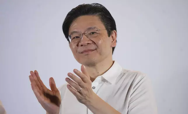Prime Minister Lawrence Wong's, from the People's Action Party (PAP), thanks his supporters and voters at an assembly area for People's Action Party supporters, on the day of the general election in Singapore, Saturday, May 3, 2025. (AP Photo/Vincent Thian)